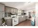 Well-lit kitchen with tile backsplash, tile floors, and gray cabinets at 5601 W Missouri Ave # 254, Glendale, AZ 85301
