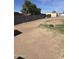Expansive backyard with a mix of grassy and dirt areas, great potential for landscaping or recreational use at 6935 W Zoe Ella Way, Peoria, AZ 85382