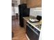 Functional kitchen area with a classic black refrigerator and stovetop, ready for your culinary creations at 6935 W Zoe Ella Way, Peoria, AZ 85382