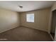 A carpeted bedroom features a standard window, neutral paint, and overhead lighting at 7126 N 19Th Ave # 108, Phoenix, AZ 85021