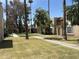 Exterior view of a multi-Gathering community with mature trees and green courtyard at 7126 N 19Th Ave # 108, Phoenix, AZ 85021