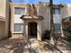 Close up of the front exterior of the townhome featuring a covered entryway and shade trees at 7126 N 19Th Ave # 108, Phoenix, AZ 85021