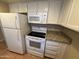 Functional kitchen featuring modern appliances, including a refrigerator, microwave, and stove with granite countertops at 7126 N 19Th Ave # 108, Phoenix, AZ 85021