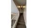 Stairway with carpet steps and white railing leading to an upper level with a light fixture at 7126 N 19Th Ave # 108, Phoenix, AZ 85021