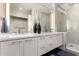 Sleek bathroom with double sinks, quartz countertops, modern cabinetry, and a glass shower at 7222 E Gainey Ranch Rd # 140, Scottsdale, AZ 85258
