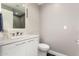 Modern bathroom featuring a white vanity with sleek fixtures and a stylishly tiled accent wall at 7222 E Gainey Ranch Rd # 140, Scottsdale, AZ 85258