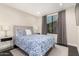 Comfortable bedroom features a large window, plush bedding, and contemporary furnishings for a relaxing retreat at 7222 E Gainey Ranch Rd # 140, Scottsdale, AZ 85258