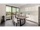 Elegant dining area with a modern table, stylish chairs, and access to the balcony at 7222 E Gainey Ranch Rd # 140, Scottsdale, AZ 85258