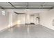 Spacious two-car garage with ample storage cabinets, a water heater, and epoxy flooring at 7222 E Gainey Ranch Rd # 140, Scottsdale, AZ 85258