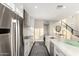 Bright, modern kitchen with stainless steel appliances, white cabinets, and a large island at 7222 E Gainey Ranch Rd # 140, Scottsdale, AZ 85258