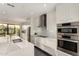 Modern kitchen with stainless steel appliances, white cabinets, and a marble countertop island at 7222 E Gainey Ranch Rd # 140, Scottsdale, AZ 85258