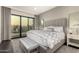 Serene main bedroom with a luxurious bed, soft lighting, and a private balcony at 7222 E Gainey Ranch Rd # 140, Scottsdale, AZ 85258