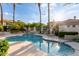 Inviting community pool area surrounded by lush landscaping and palm trees, perfect for relaxation at 7222 E Gainey Ranch Rd # 140, Scottsdale, AZ 85258