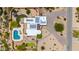 Aerial view of luxury estate with solar panels, pool, and lush landscaping, offering privacy and outdoor enjoyment at 8255 E Yearling Rd, Scottsdale, AZ 85255