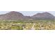 Overhead shot of a neighborhood in a desert landscape, framed by rugged mountains and sparse vegetation at 8255 E Yearling Rd, Scottsdale, AZ 85255