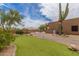 Well-manicured backyard with a putting green, desert landscaping, and views of the pool at 8255 E Yearling Rd, Scottsdale, AZ 85255