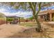 Lush backyard featuring an outdoor pergola with seating, a putting green, and desert landscaping at 8255 E Yearling Rd, Scottsdale, AZ 85255