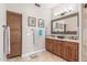Well-appointed bathroom featuring double sinks, a large mirror, and a linen cabinet for ample storage at 8255 E Yearling Rd, Scottsdale, AZ 85255