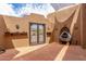 Private courtyard with decorative fountain, flagstone flooring, and secure wrought iron gate at 8255 E Yearling Rd, Scottsdale, AZ 85255