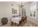 Bright dining room featuring neutral decor, shuttered windows, and elegant chandelier at 8255 E Yearling Rd, Scottsdale, AZ 85255