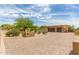 Expansive brick driveway leading to a tan home surrounded by desert landscaping at 8255 E Yearling Rd, Scottsdale, AZ 85255