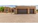 Stunning Southwestern-style home featuring a two-car garage and well-manicured desert landscaping at 8255 E Yearling Rd, Scottsdale, AZ 85255