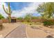 Serene front yard featuring a brick pathway, desert landscaping, and a charming seating area at 8255 E Yearling Rd, Scottsdale, AZ 85255