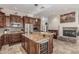 Open kitchen layout with dark wood cabinets, stainless steel appliances, a center island, and a built-in wine fridge at 8255 E Yearling Rd, Scottsdale, AZ 85255