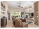 Inviting living room featuring a stone fireplace and sliding doors to a patio at 8255 E Yearling Rd, Scottsdale, AZ 85255