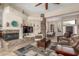 Open-concept living room with stone fireplace, tile floors, and dining area at 8255 E Yearling Rd, Scottsdale, AZ 85255