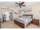 Spacious main bedroom with a king-sized bed, ensuite bathroom, and a sliding barn door to the walk-in closet at 8255 E Yearling Rd, Scottsdale, AZ 85255
