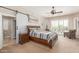 Serene main bedroom featuring a sliding barn door to the bathroom, neutral tones, and ample natural light at 8255 E Yearling Rd, Scottsdale, AZ 85255