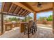 Inviting outdoor kitchen and bar area featuring a built-in grill, counter seating, and a covered patio at 8255 E Yearling Rd, Scottsdale, AZ 85255