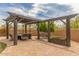 Charming outdoor pergola with seating, a swing, and ambient lighting, perfect for entertaining at 8255 E Yearling Rd, Scottsdale, AZ 85255