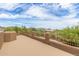 Expansive rooftop patio with desert views, featuring stucco railings, offering serene outdoor living space at 8255 E Yearling Rd, Scottsdale, AZ 85255