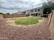 Large backyard featuring a well-maintained lawn, low-maintenance rock landscaping, and a covered patio at 8514 S 49Th Dr, Laveen, AZ 85339
