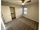 Bedroom featuring a closet with sliding doors, neutral carpet, and a ceiling fan with light at 8514 S 49Th Dr, Laveen, AZ 85339