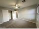 Bedroom showcasing a closet with sliding doors, neutral carpet, and a ceiling fan with light at 8514 S 49Th Dr, Laveen, AZ 85339