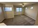 Spacious bedroom filled with natural light, featuring neutral carpeting and a modern ceiling fan at 8514 S 49Th Dr, Laveen, AZ 85339