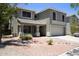 Two-story home showcasing desert landscaping, a covered porch, and neutral earthtone colors at 8514 S 49Th Dr, Laveen, AZ 85339