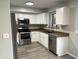 Well-lit kitchen featuring stainless appliances, white cabinets and stone countertops at 8514 S 49Th Dr, Laveen, AZ 85339