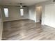 Expansive living area showcases modern floors, ample windows, and a sleek ceiling fan at 8514 S 49Th Dr, Laveen, AZ 85339