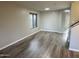 Open living room showcasing wood floors, neutral paint, and large window at 8514 S 49Th Dr, Laveen, AZ 85339