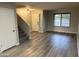 Light-filled living room featuring wood floors, a staircase, and a large window at 8514 S 49Th Dr, Laveen, AZ 85339