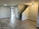 Bright living room featuring wood floors, neutral walls, staircase and exterior view at 8514 S 49Th Dr, Laveen, AZ 85339
