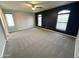 Main bedroom with plush carpet, ceiling fan, and large windows for natural light at 8514 S 49Th Dr, Laveen, AZ 85339