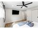 Modern bedroom with a large flat screen television, clean lines, and bright natural lighting at 8714 E Plaza Ave, Scottsdale, AZ 85250