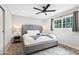 Beautiful bedroom with a comfortable bed, modern fan, stylish rug and lots of natural light at 8714 E Plaza Ave, Scottsdale, AZ 85250