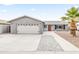 Single-story home with a two-car garage, red front door and mature palm tree at 8714 E Plaza Ave, Scottsdale, AZ 85250