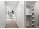 Hallway featuring a closet and an entrance to a room with a tv at 8714 E Plaza Ave, Scottsdale, AZ 85250